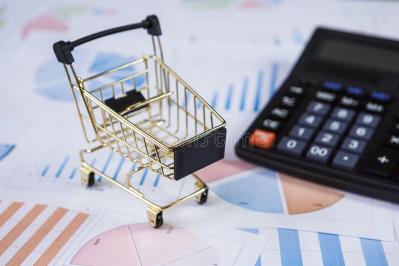 Shopping Carts with Calculator on the Financial Graphs Stock Image