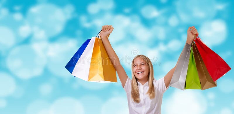 Shopping,holiday and tourism concept - happy cheerful girl with shopping bags over blurred background stock photos Shopping,holiday and tourism concept - happy cheerful girl with shopping bags over blurred background stock photos
