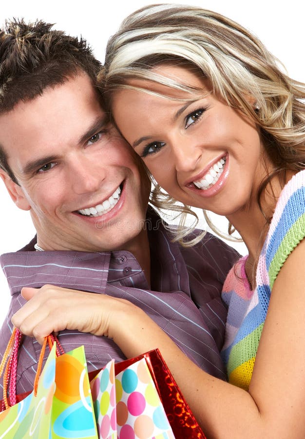 Shopping couple smiling. Isolated over white background. Shopping couple smiling. Isolated over white background