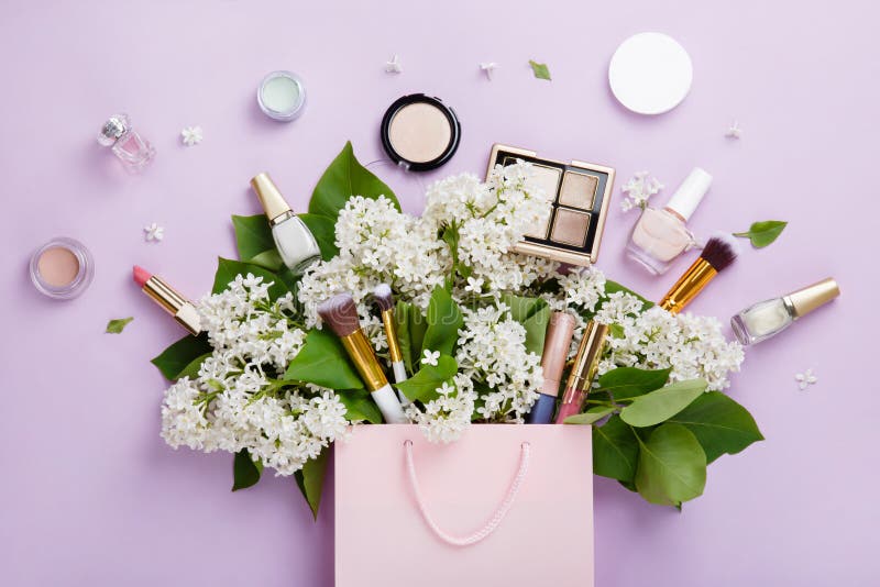 Shopping of natural woman make up cosmetics with spring white lilac bloom.
