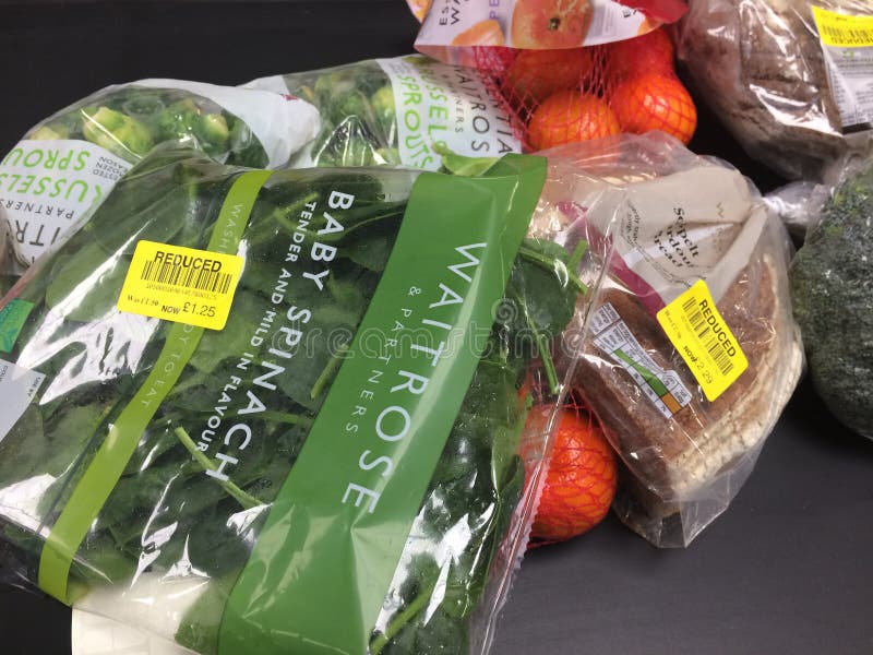 Close up view of grocery foods on conveyor belt. Yellow reduced labels on spinach packaging and soda bread. plastic nets with orange tangerines and plastic wrapped broccoli head. Location Waitrose supermarket, Rushden, Northampton, UK. 6th February 2023. Close up view of grocery foods on conveyor belt. Yellow reduced labels on spinach packaging and soda bread. plastic nets with orange tangerines and plastic wrapped broccoli head. Location Waitrose supermarket, Rushden, Northampton, UK. 6th February 2023