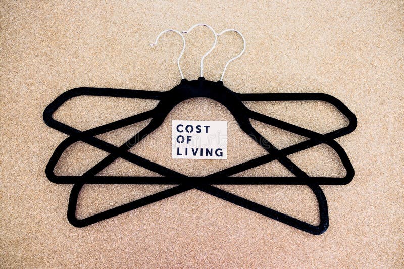 Shopping and purchasing power, group of clothes hangers with Cost of Living text in the middle concept of buyers reducing their royalty free stock images Shopping and purchasing power, group of clothes hangers with Cost of Living text in the middle concept of buyers reducing their royalty free stock images