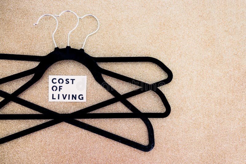 Shopping and purchasing power, group of clothes hangers with Cost of Living text in the middle concept of buyers reducing their royalty free stock photos Shopping and purchasing power, group of clothes hangers with Cost of Living text in the middle concept of buyers reducing their royalty free stock photos