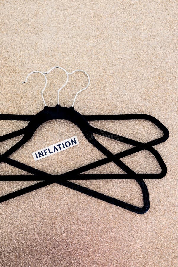 Shopping and purchasing power, group of clothes hangers with Inflation text in the middle concept of buyers reducing their royalty free stock photo Shopping and purchasing power, group of clothes hangers with Inflation text in the middle concept of buyers reducing their royalty free stock photo
