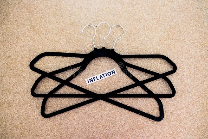 Shopping and purchasing power, group of clothes hangers with Inflation text in the middle concept of buyers reducing their royalty free stock image Shopping and purchasing power, group of clothes hangers with Inflation text in the middle concept of buyers reducing their royalty free stock image
