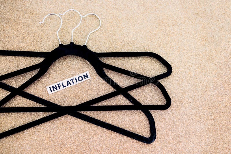 Shopping and purchasing power, group of clothes hangers with Inflation text in the middle concept of buyers reducing their royalty free stock photography Shopping and purchasing power, group of clothes hangers with Inflation text in the middle concept of buyers reducing their royalty free stock photography