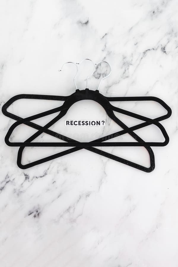 Shopping and purchasing power, group of clothes hangers with Recession text in the middle concept of buyers reducing their royalty free stock photo Shopping and purchasing power, group of clothes hangers with Recession text in the middle concept of buyers reducing their royalty free stock photo
