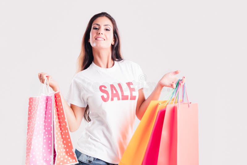 Shopping sale woman showing shopping bag with a shirt sale written stock photo