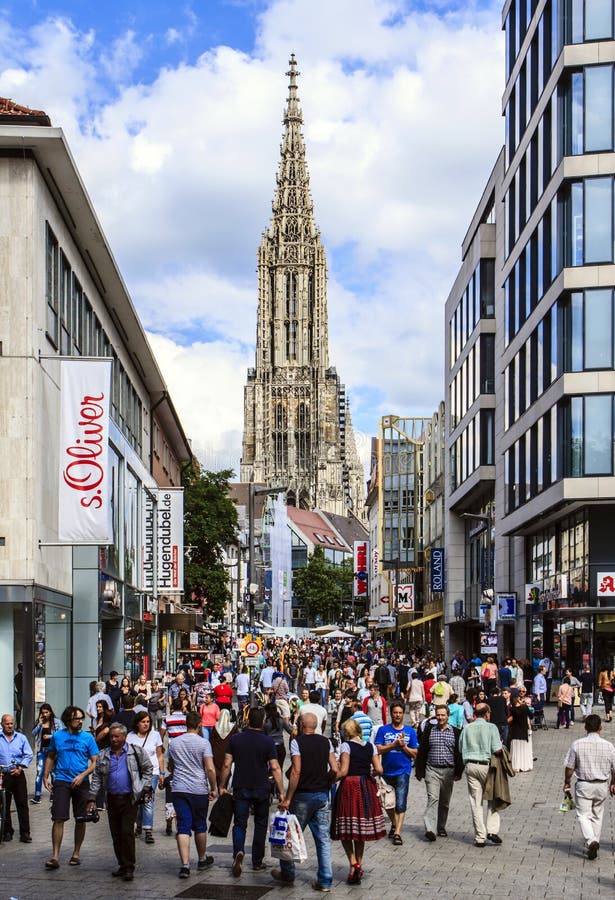 Shopping street in the center of Ulm. The Cathedral or Munster with the highest church tower in Europa on the background. Shopping street in the center of Ulm. The Cathedral or Munster with the highest church tower in Europa on the background.