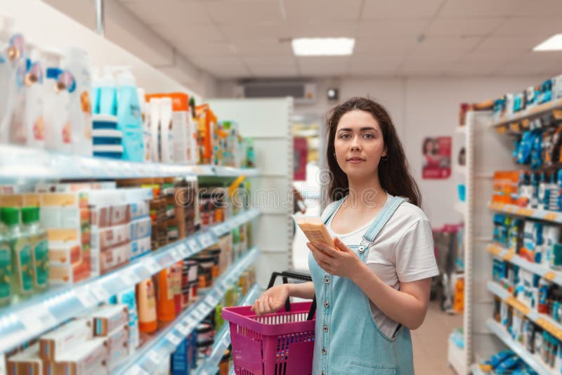Shopping trip. Young beautiful selects the hair in the beauty supply store royalty free stock photos Shopping trip. Young beautiful selects the hair in the beauty supply store royalty free stock photos