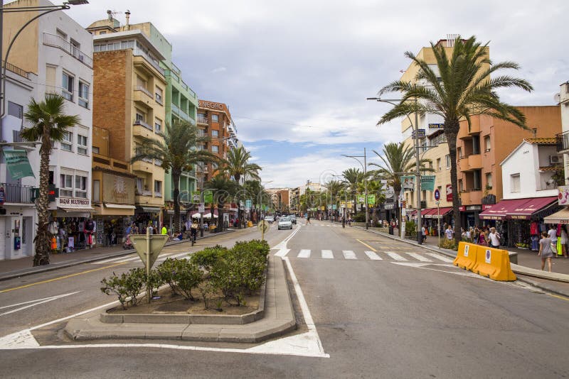 Shops and cafes near the narrow streets of Lloret de Mar. Downtown of Lloret, Spain.