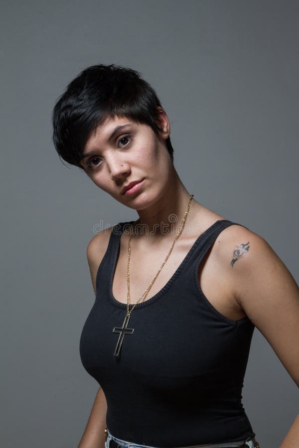 Short Hair Brunette Woman Looking At Camera Indoors Wearing A Stock