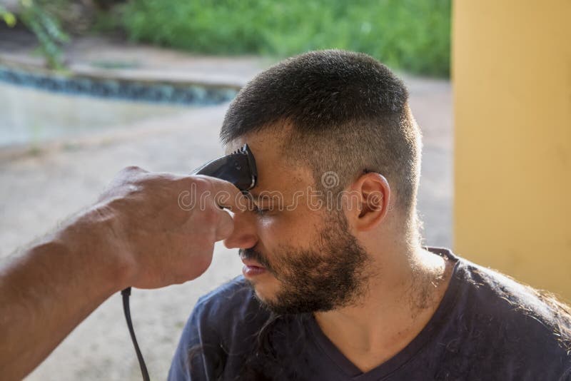 short haircut young soldier having his hair cut outdoors military style 233172000