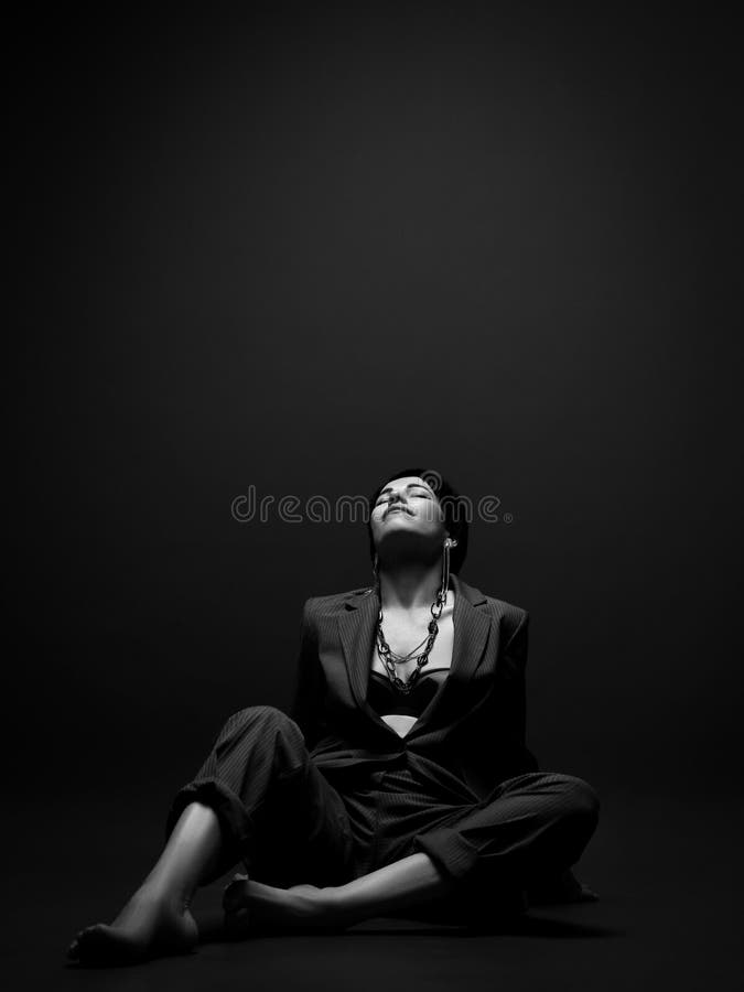 Pretty Short Haired Brunette Woman In Business Smart Casual Suit On Naked Body Sits On Floor