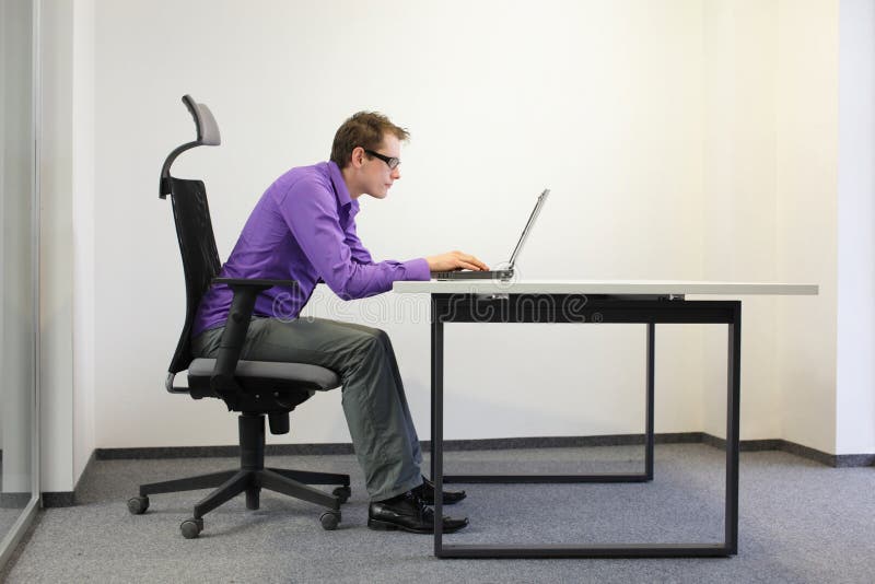 Shortsighted businessman bad sitting posture at laptop