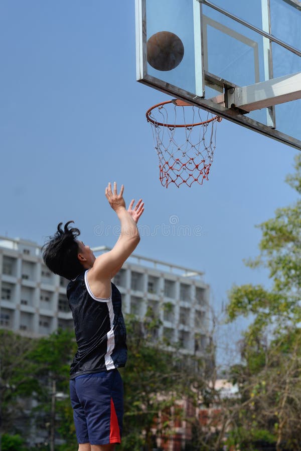 Shot of Basketball Player Throwing a Ball Toward Basket, Training on