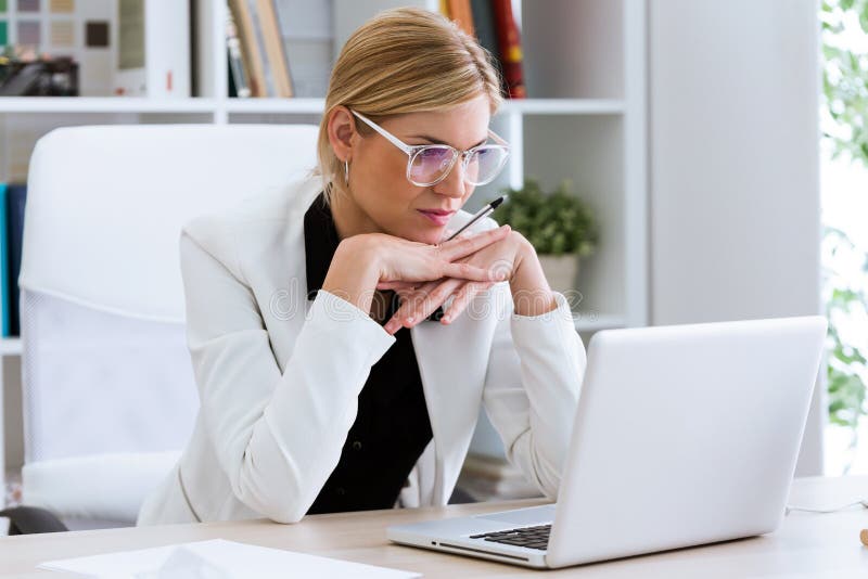 Business young woman working with her laptop in the office.