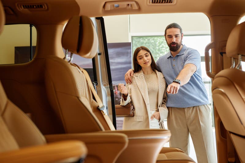 Couple Discussing Car Cabin Interior Buying Automobile at Dealership Center stock photos