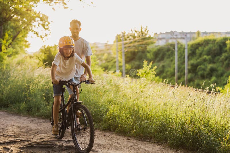 Father Teaching His Son How To Ride a Bicycle Stock Image - Image of ...