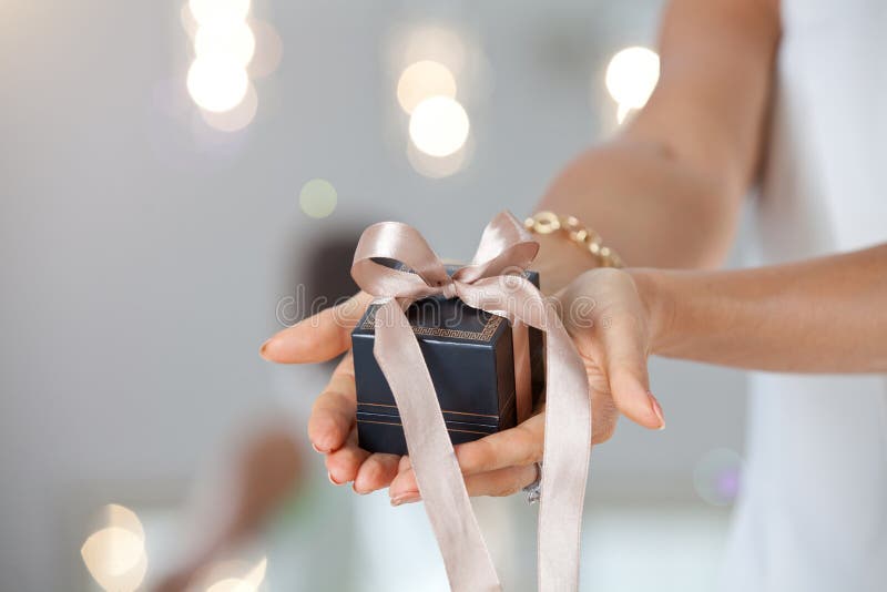 Shot of female hands holding a small gift box.