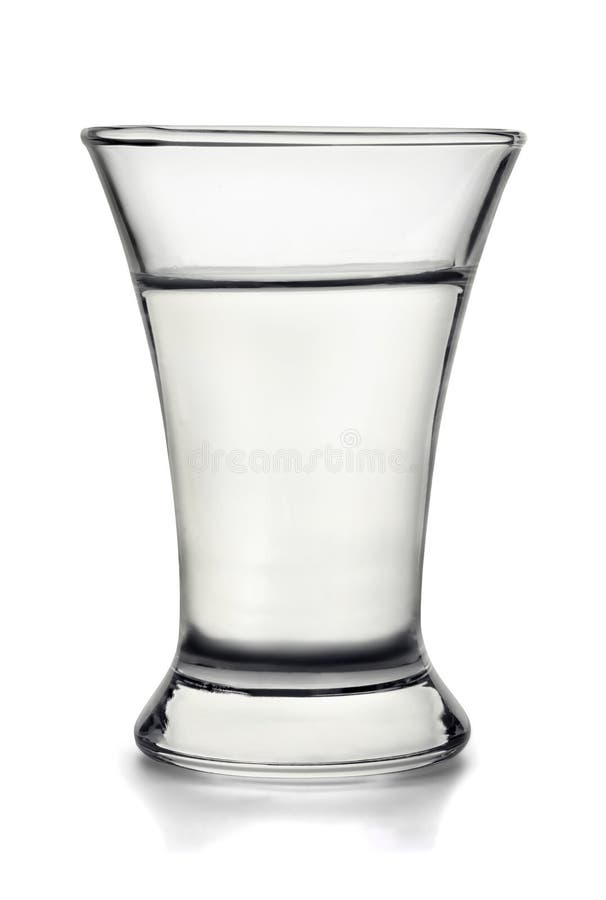 Small shot glass filled with alcohol on white