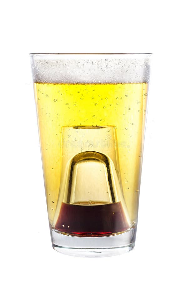 A Shot Glass Filled With Alcohol Placed Inside A Glass With Beer Stock