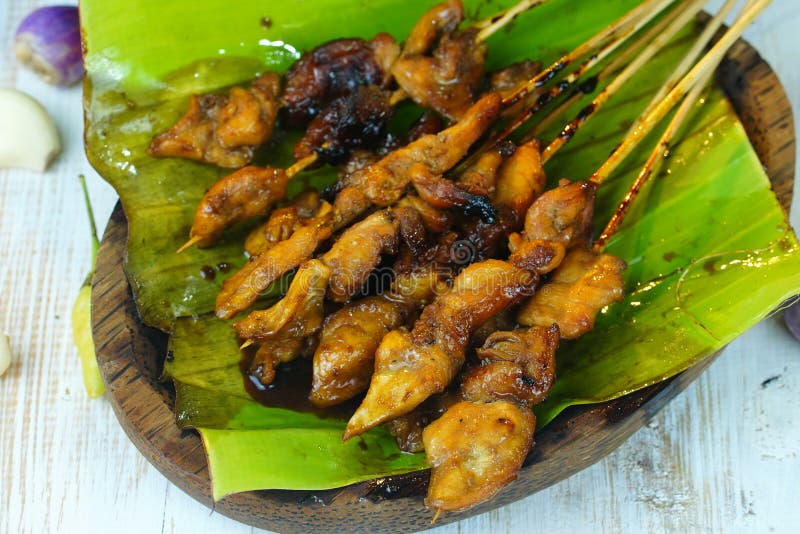 Indonesian Chicken Satay Served with Peanut Sauce on Banana Leaf Stock