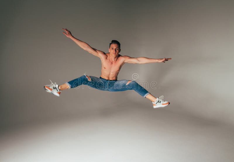 Shot of mad, crazy, cheerful, successful, lucky guy in casual outfit, jeans, jumping with hands up,triumphant, gesturing against w