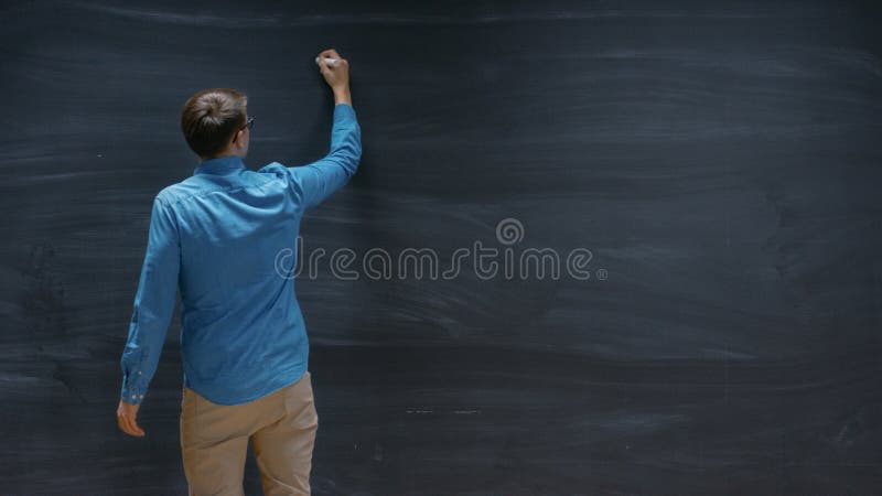 Shot of a Man Starting to Write on the Blackboard. Empty Chalkboard Perfect for royalty free stock photos