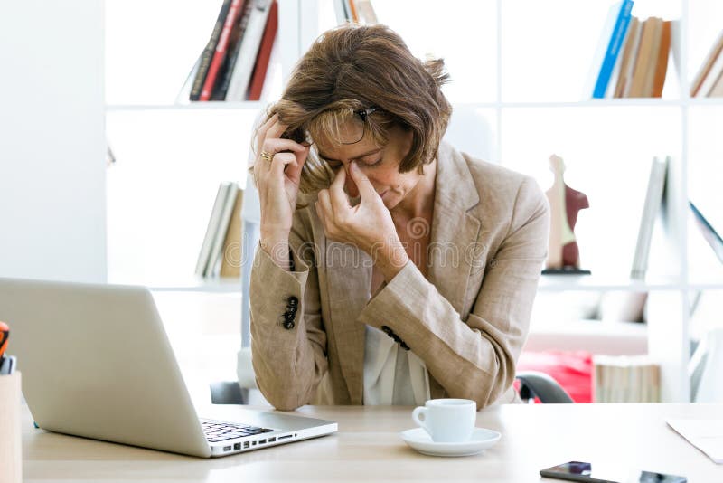 The Overworked Office Ladys Cafe Crush Overworked Businesswoman Suffering from Headache in the Office. Stock