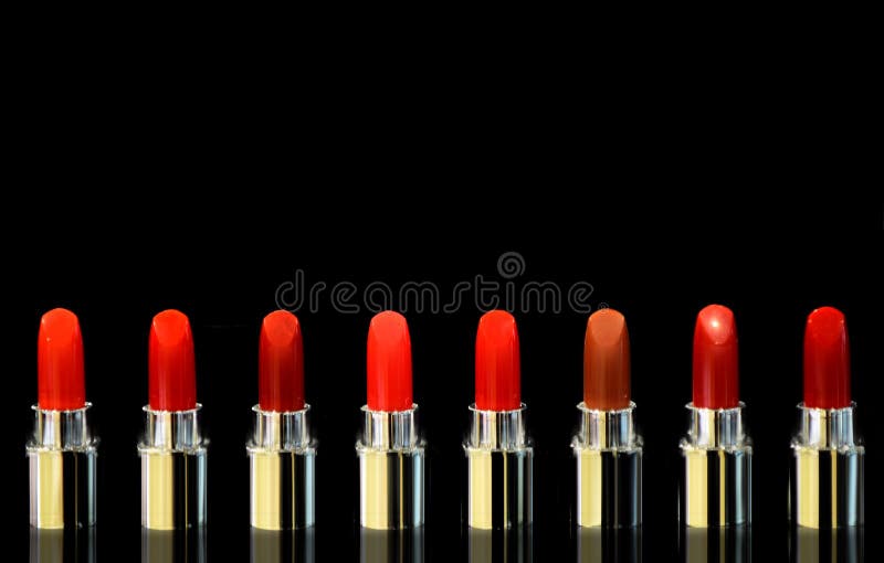 Shot of red lipsticks of different color. on black background. Cosmetics concept. Beautiful Luxury Modern High stock image Shot of red lipsticks of different color. on black background. Cosmetics concept. Beautiful Luxury Modern High stock image