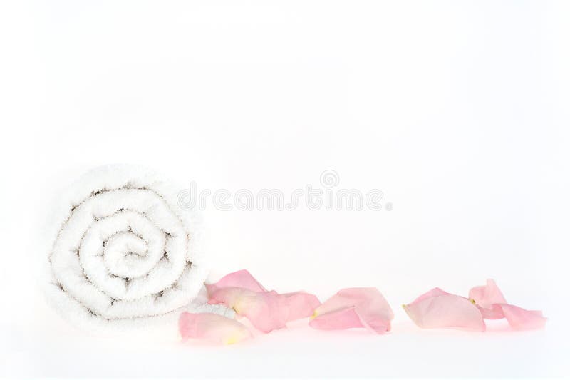 Shot of roll of towel with petals in a spa