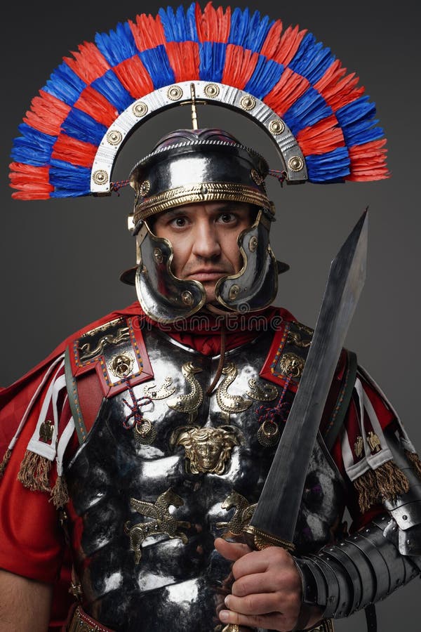 Roman Warrior Dressed in Armor Posing Against Dark Background Stock ...