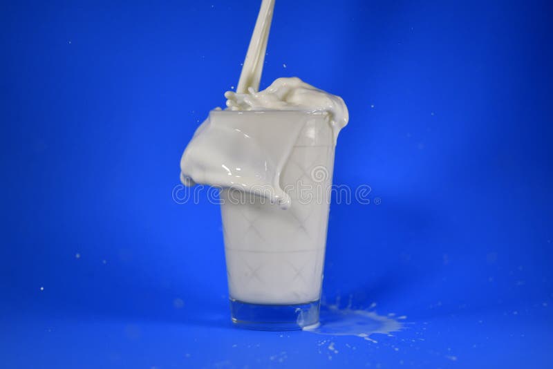 Shot of Splashing Milk from a Cup Stock Photo Image of blue, milk