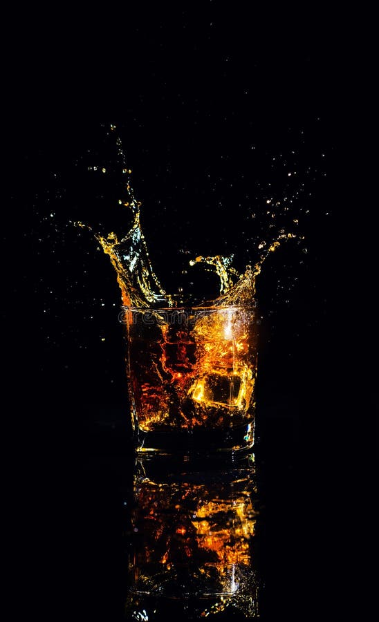 shot of whiskey with splash on black background, brandy in a glass royalty free stock images shot of whiskey with splash on black background, brandy in a glass royalty free stock images