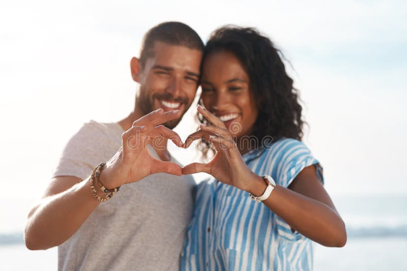 Youve Taught Me The True Meaning Of Love. A Couple Forming A Heart Shape  With Their Hands While Sitting On The Beach. Stock Photo, Picture and  Royalty Free Image. Image 198911221.