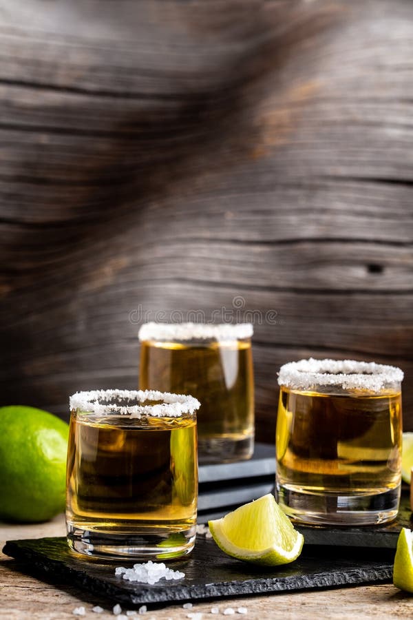 Shots of Gold Mexican Tequila with Lime and Salt. Alcoholic Mexican ...