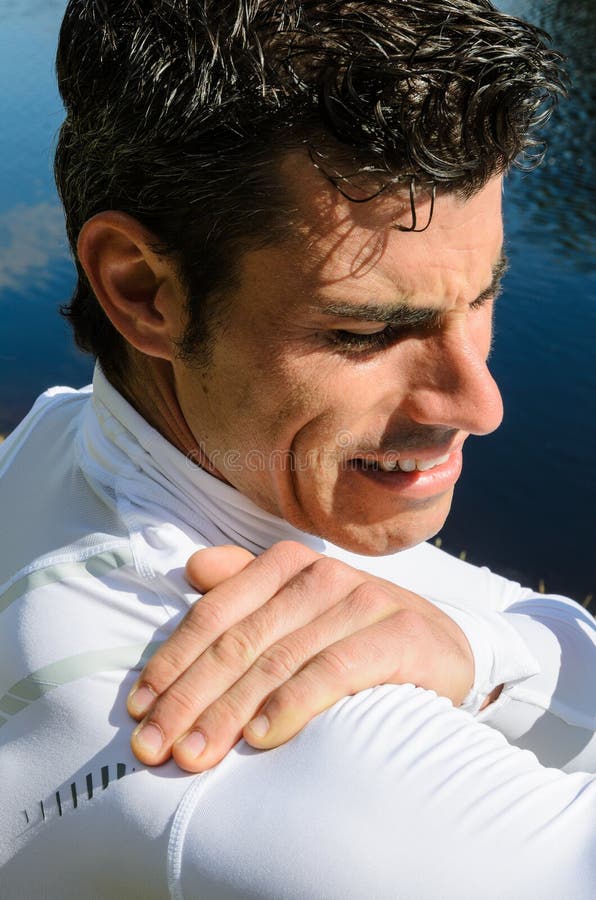 Sportsman feels pain because of a shoulder injury. Spasm ache stock images, royalty-free photos and pictures