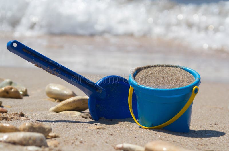 Shovel and bucket on sand