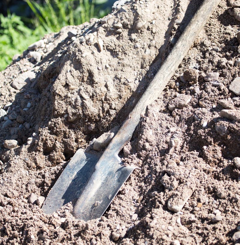 Shovel on a Mixture of Concrete at the Construction Site Stock Photo