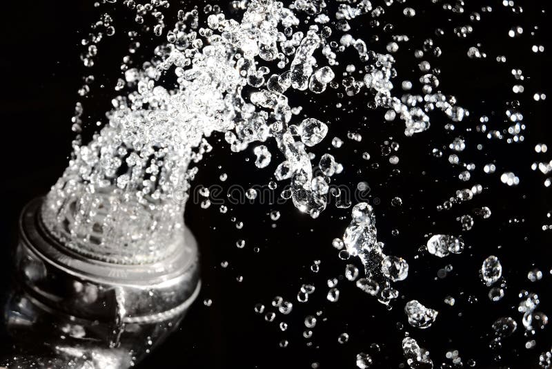 Shower head with water on black stock image