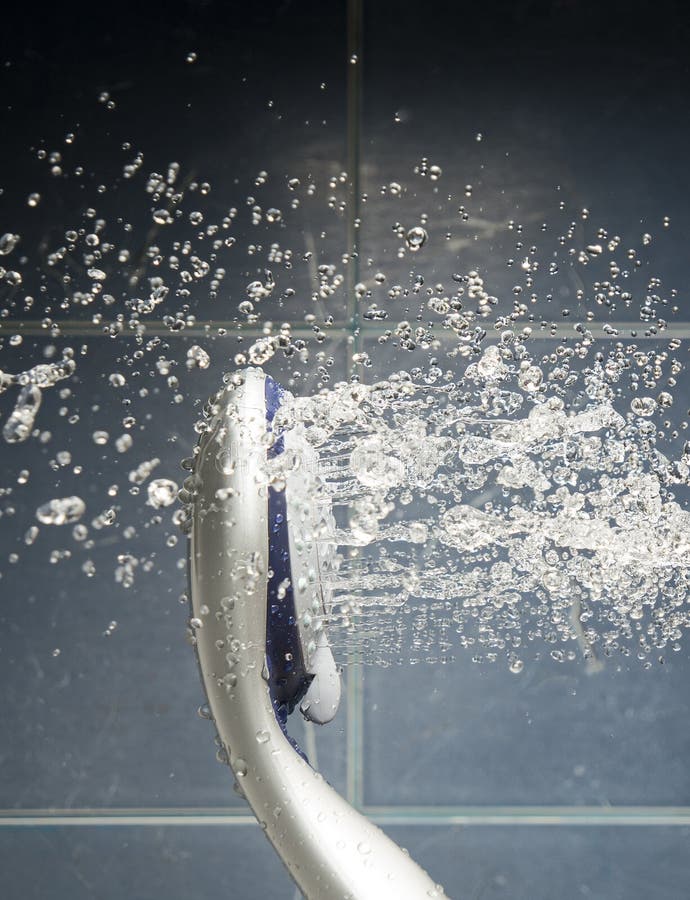 Shower Head with Flow of Water Levitate in the Air on Blue Backg Stock