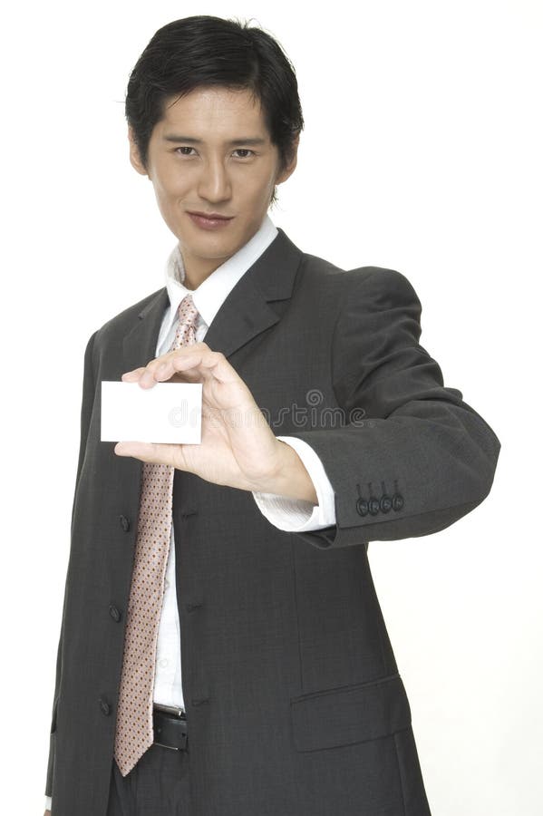 Showing Business Card. An asian businessman holds up his blank business card