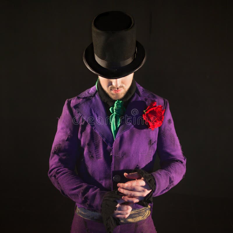 showman Actor, presentador o actor de sexo masculino joven en etapa El individuo en la camiseta púrpura y el cilindro