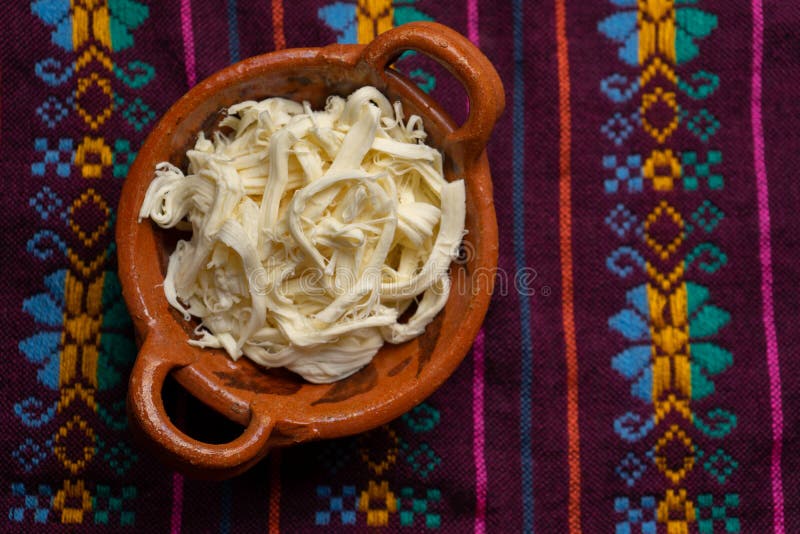 Shredded Oaxaca Cheese Also Called Quesillo on Rustic Background