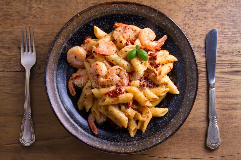 Shrimp pasta with sun dried tomatoes and basil in creamy mozzarella sauce. 