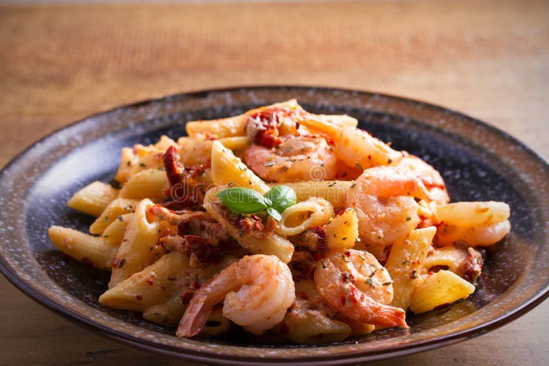 Shrimp penne with sun dried tomatoes and basil in creamy mozzarella sauce. 