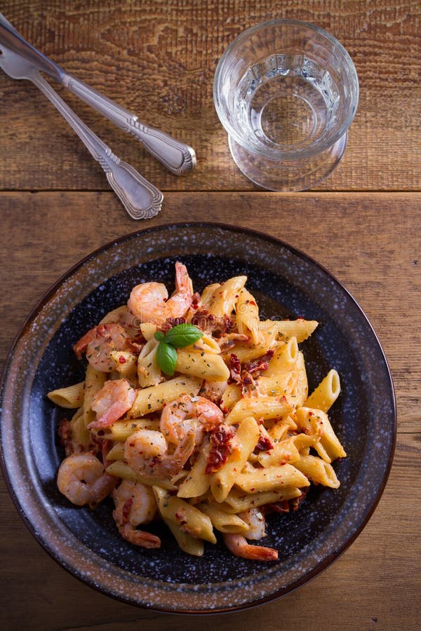 Shrimp penne with sun dried tomatoes and basil in creamy mozzarella sauce. 