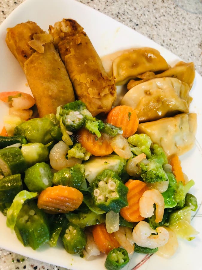 Shrimp Vegetable Stir Fry, Spring Egg Rolls, Pork Raviolis, Stock Photo
