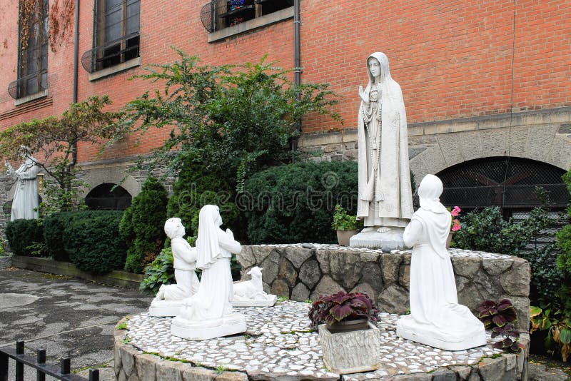 New York, USA - September 27, 2016: Holy statues outside the Church of St. Anthony of Padua, a Catholic parish church in the Roman Catholic Archdiocese of New York, located at 155 Sullivan Street. New York, USA - September 27, 2016: Holy statues outside the Church of St. Anthony of Padua, a Catholic parish church in the Roman Catholic Archdiocese of New York, located at 155 Sullivan Street